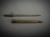 two knives are laying side by side on a gray surface