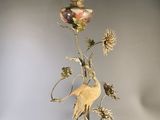 a lamp that is sitting on a table with a bird on it