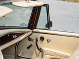 the interior of a car with the door open and the driver ' s seat down