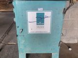 a blue box with a sign on it in a garage