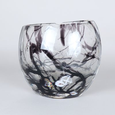 a glass vase with a black and white design on it