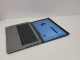 a laptop computer sitting on a table with a blue screen