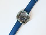 a watch that is sitting on a blue strap