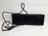 a black keyboard and a mouse on a white surface