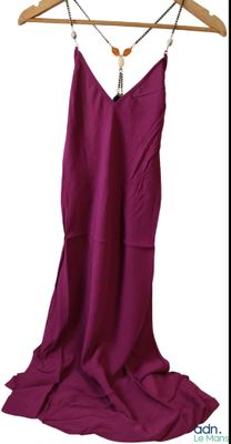 a picture of a purple dress hanging on a wooden hanger