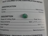 a close up of a green gemstone on a white background