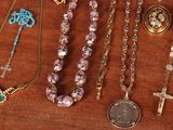 many different types of necklaces on a wooden table