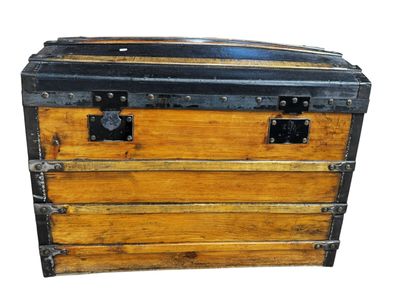 a wooden chest with metal latches on it