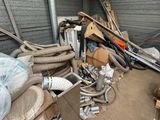 a pile of junk in a storage room with a lot of hoses