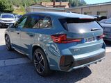 bmw x2 suv parked in a parking lot with other cars in the background
