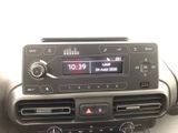 a radio in the center of a car with a clock on it