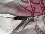 a close up of a mascara brush on a pink surface