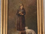 tableau représentant une fillette et un chien, dans un cadre doré accroché au mur