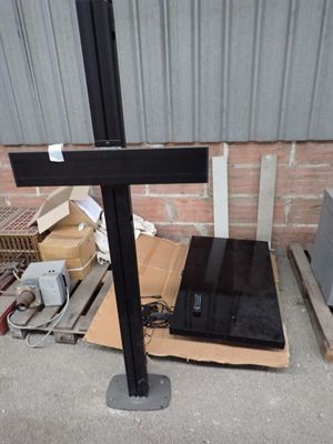 a laptop computer sitting on top of a wooden cross