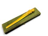 a small wooden box with a yellow toothbrush in it