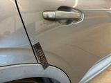 a close up of a car door handle with a sticker on it