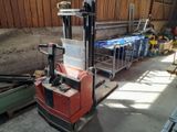 a forklift truck that is parked in a warehouse