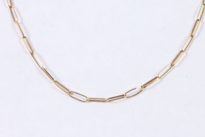 a close up of a gold chain necklace on a white background
