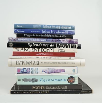 many books stacked on top of each other on a table