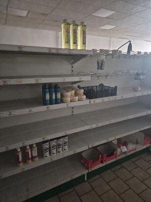many empty shelves in a store that are on the floor