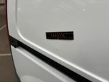 a close up of a white van with a sticker on it