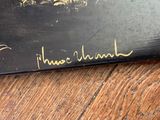 a black book with gold writing on it on a wooden table