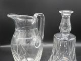 two clear glass vases sitting on top of a table