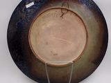 a plate that is sitting on a stand on a table