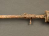 an old rusted metal pipe on a gray surface