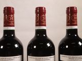 three bottles of wine that are sitting on a table