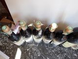 several bottles of wine are lined up on a table