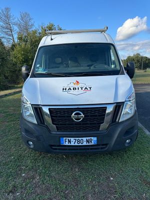 a white van parked in a parking lot with trees in the background