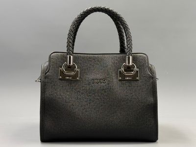 a black handbag with a braid handle on a white background