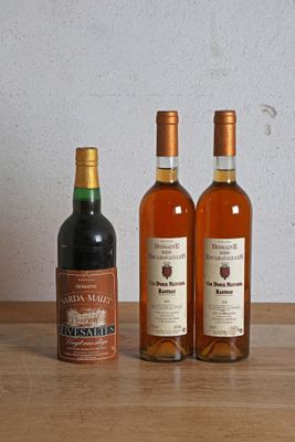 trois bouteilles de vin posées sur une table, l'une à côté de l'autre