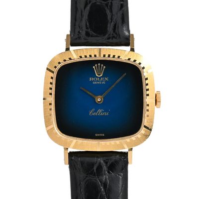 a close up of a wrist watch with a blue face
