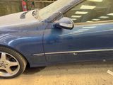 a blue car parked on the side of the street