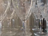 many empty wine glasses sitting on a glass table