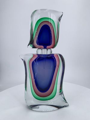two glass vases stacked on top of each other on a table