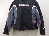 the jacket is hanging on a hanger on the wall