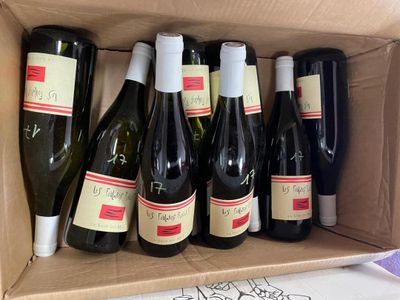 many bottles of wine in a box on the table