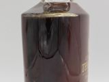 an image of a bottle of liquor sitting on top of a white surface