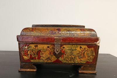 a wooden box with a painting on it on a table