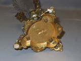 a gold clock sitting on top of a white table