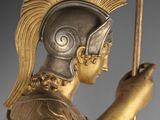 statue of a roman soldier holding a spear and shield