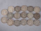 some coins are arranged in a row on a white surface