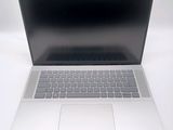 an open laptop computer sitting on top of a white table