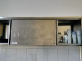 a metal cabinet with a mirror above it in a bathroom