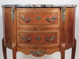 a marble top chest of drawers with a marble top