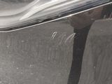 a reflection of a person in a mirror on the side of a car