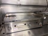 stainless steel counter top in a commercial kitchen with a fryer on it